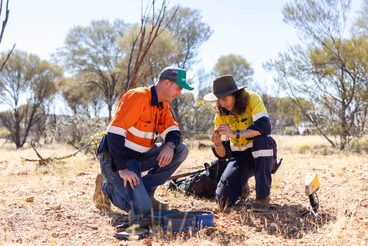 Two workers surveying minerals in the Outback